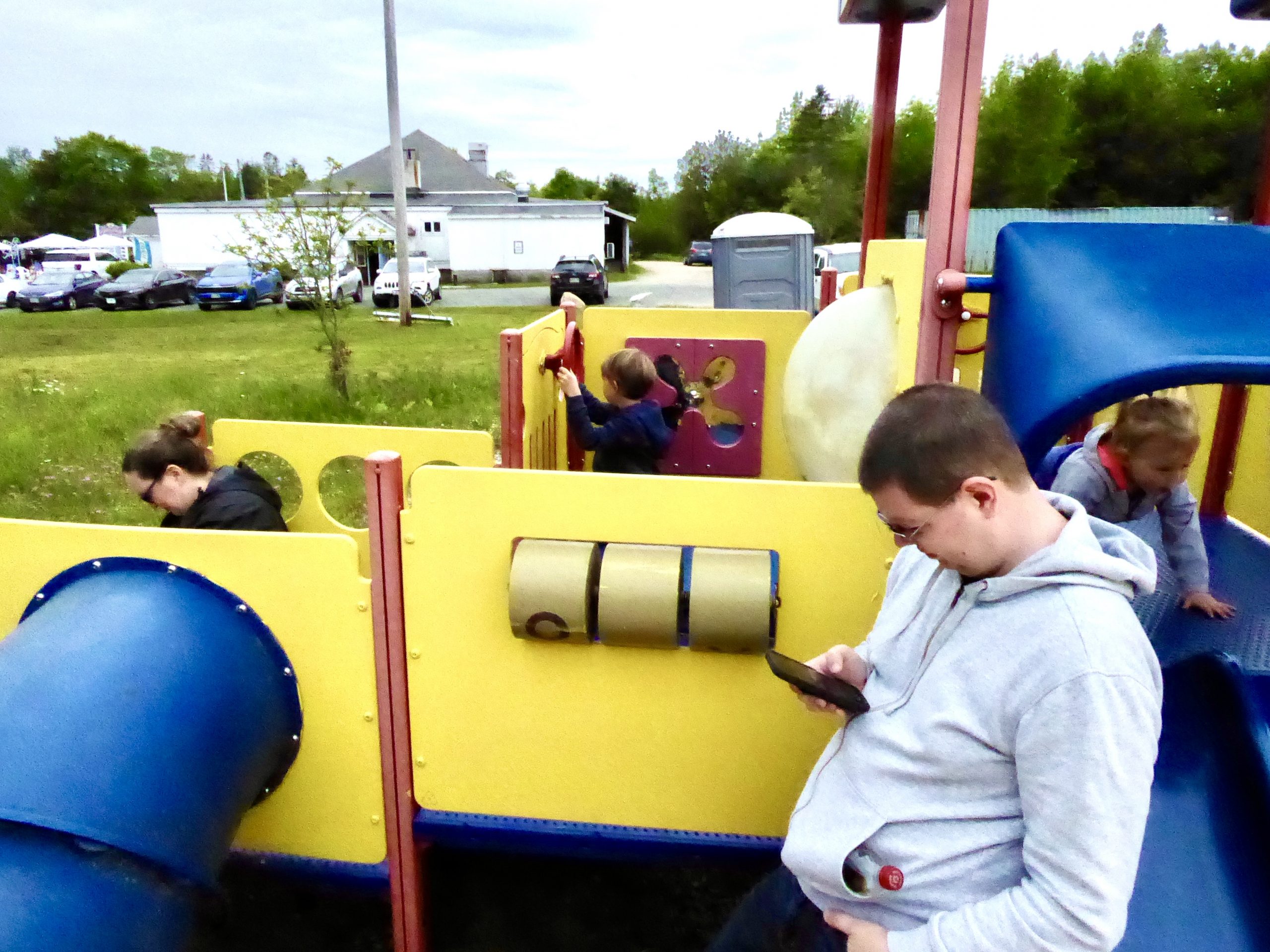 Visitors to Sorrento-Sullivan Recreation Center: two children on a playground climbing, sliding, steering apparatus.